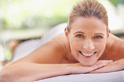 Buy stock photo Woman, portrait and spa luxury for massage wellness at zen resort for tropical holiday, vacation or stress relief. Female person, face and smile on table or relax leisure for comfort, pamper or calm