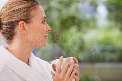 Buy stock photo Shot of an attractive mature woman enjoying a hot drink at a spa