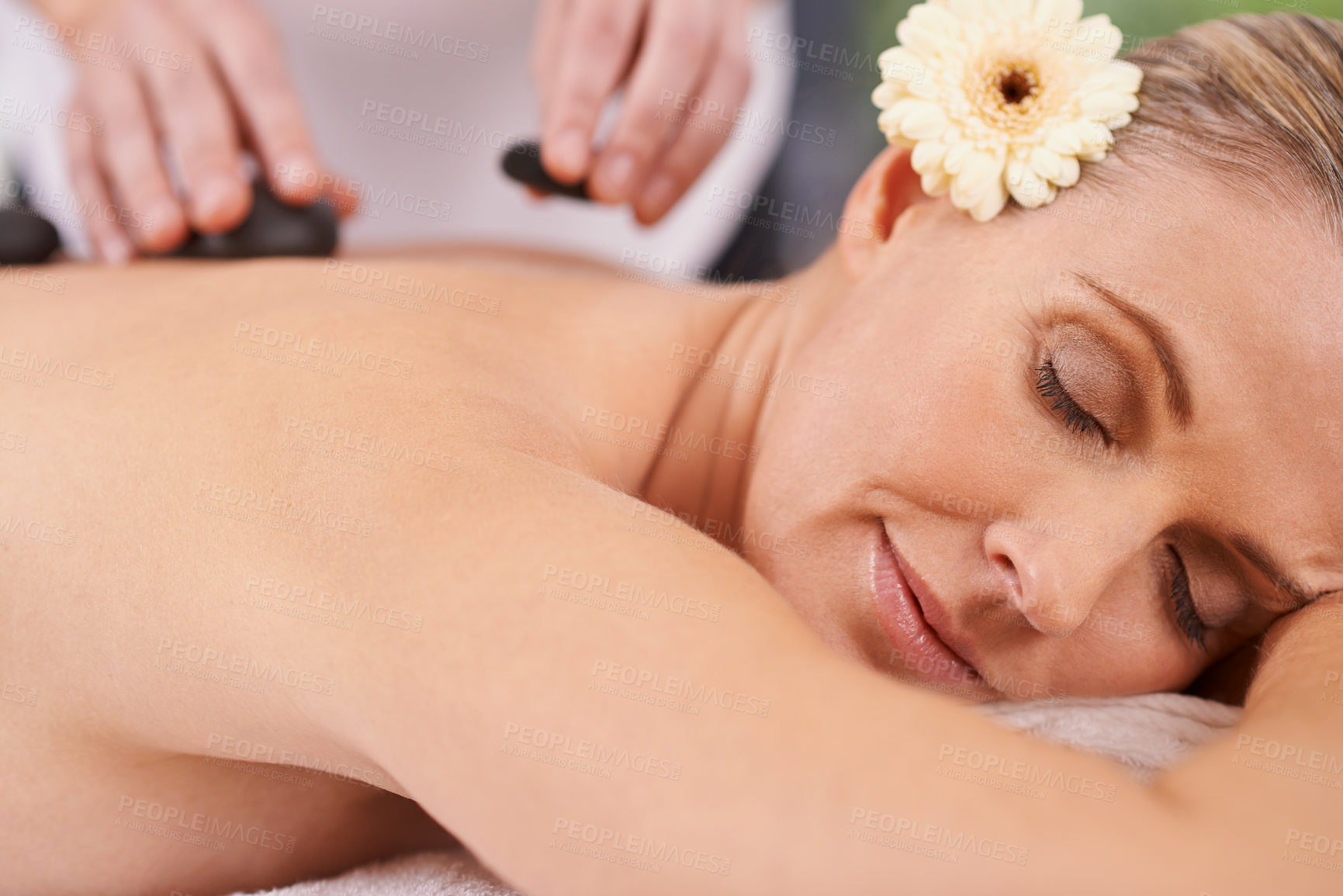 Buy stock photo Woman, spa and hands with hot stone for massage, wellness and relax in hotel. Physical therapy, holistic and female person in holiday or vacation in California for health, peace and back skin detox