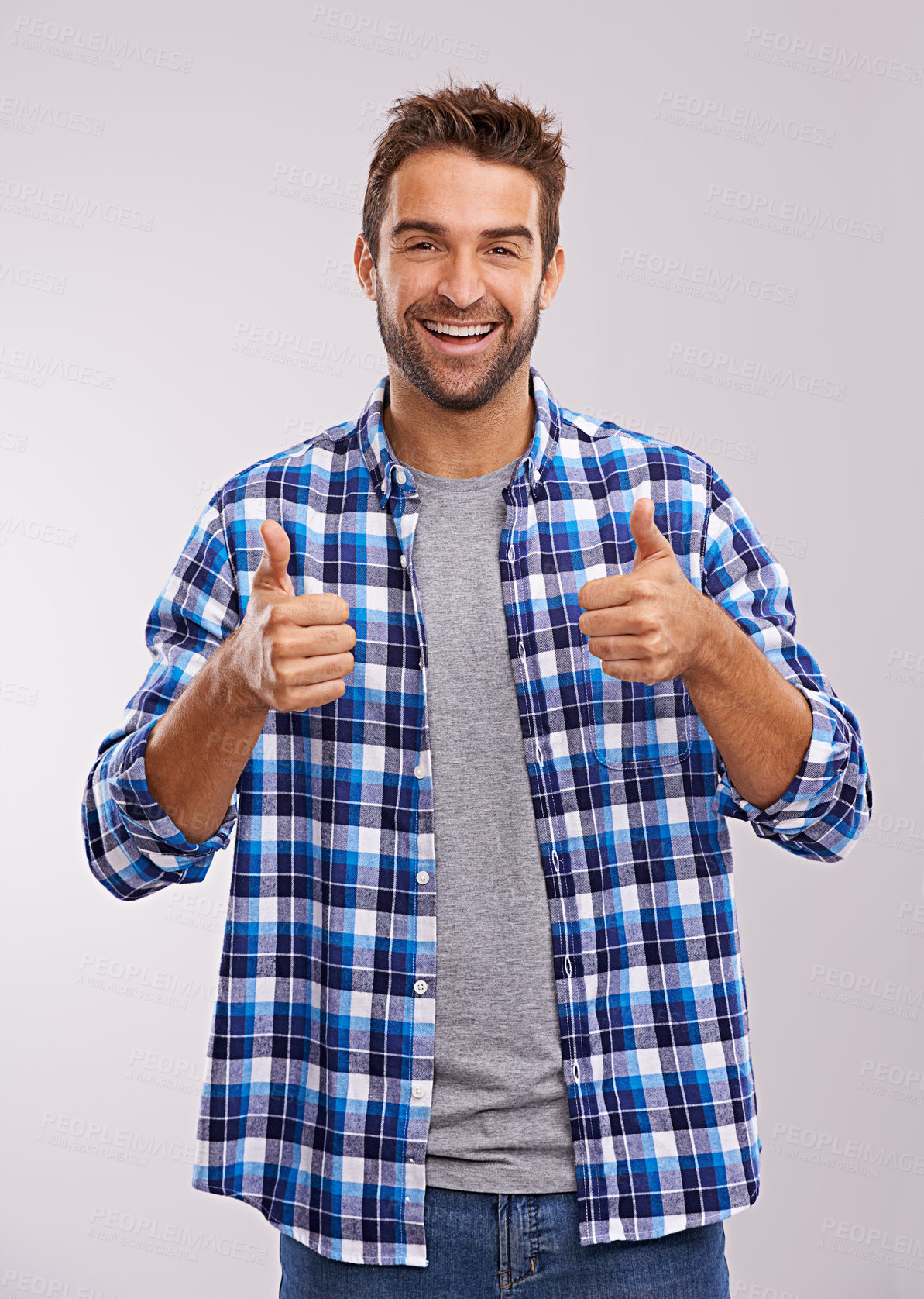 Buy stock photo Portrait, smile and man with thumbs up for success, winning or feedback for support isolated on a gray studio background. Excited person, gesture and like hand sign for emoji, agreement or trust