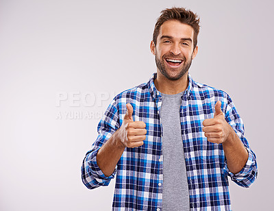 Buy stock photo Portrait, excited and man with thumbs up for success, winning or feedback isolated on a gray studio background mockup space. Face, happy person and like hand gesture for emoji, agreement or thank you
