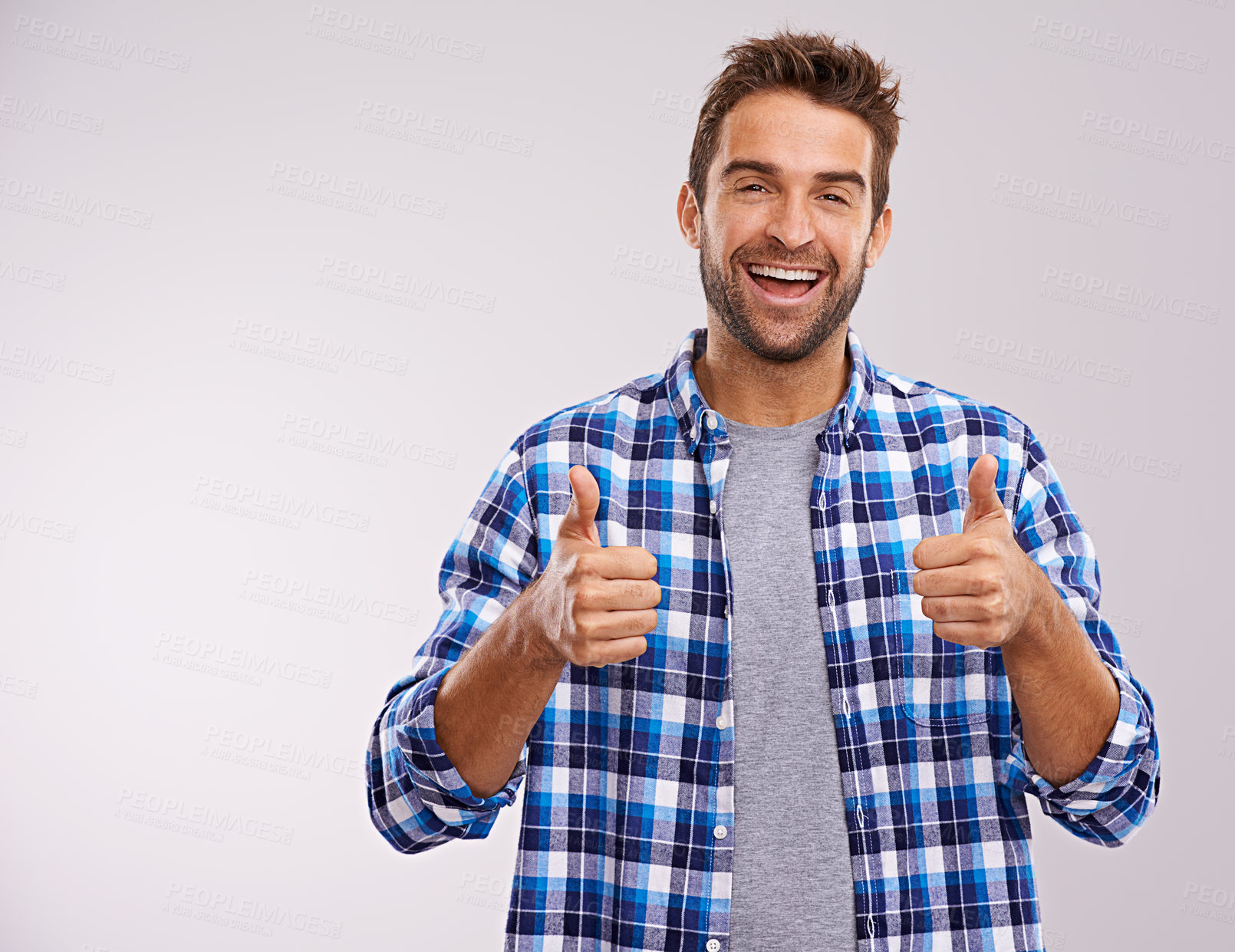 Buy stock photo Portrait, excited and man with thumbs up for success, winning or feedback isolated on a gray studio background mockup space. Face, happy person and like hand gesture for emoji, agreement or thank you