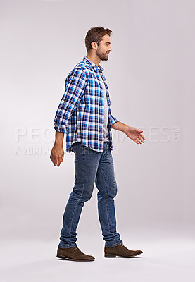 Buy stock photo Man, fashion and smile in studio, walking and casual flannel shirt for style on white background. Male person, outfit and confidence for plaid trend, happy and profile in aesthetic or cool guy