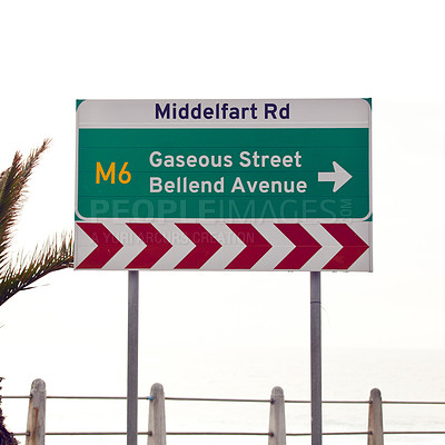 Buy stock photo Road sign, intersection and direction in city with arrow for grammar, mistake or text for gas for driving in neighborhood. Buildings, error and funny signage with joke, fart and warning in Cape Town