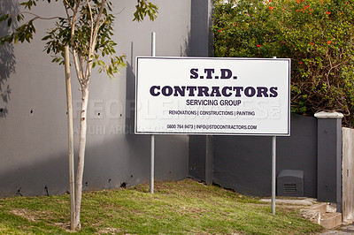 Buy stock photo Contractor, poster and sign for advertising, outdoor and mistake with grammar, humor and comic text on lawn. Real estate group, board and error with language, houses and construction company on grass