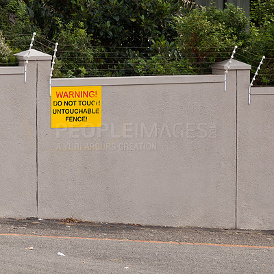 Buy stock photo Electrical fence, warning and sign on wall of property for caution, notification and information. Public signage, symbol and building with board, poster and for attention, message and safety message