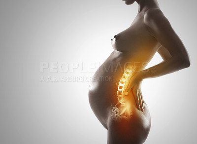 Buy stock photo A cropped view of a pregnant woman holding her lower back in pain