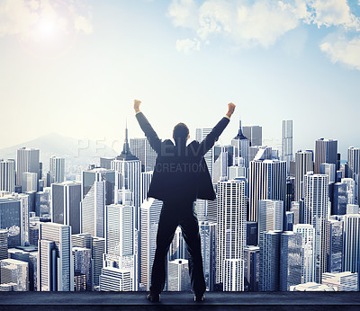 Buy stock photo Rear view of a businessman with his arms raised while looking at a cityscape