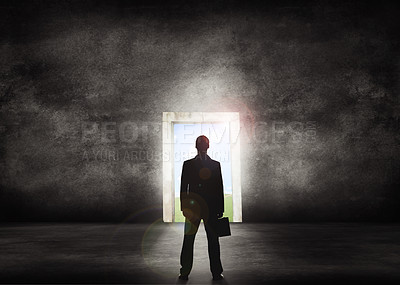 Buy stock photo Silhouette of businessman standing in front of a light door way to success. Business professional looking to a bright future ahead of him. Isolated corporate man around copy space background.