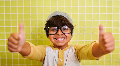Buy stock photo Shot of a cute little boy wearing glasses and a beanie showing thumbs up
