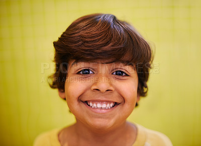 Buy stock photo Happy, portrait and excited boy child in a house playful, confident or curious against a yellow wall background. Face, smile and cheerful Indian kid at home in India on vacation, holiday or weekend