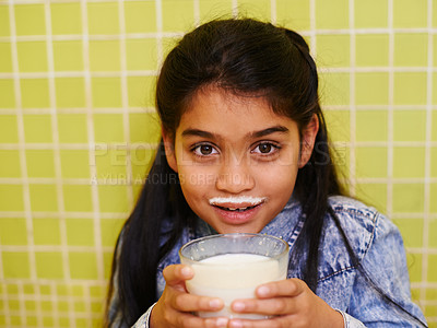 Buy stock photo Milk, moustache or girl child portrait in house with healthy breakfast drink on yellow wall background. Protein, dairy and face of kid in india with milkshake for balance, energy or calcium nutrition