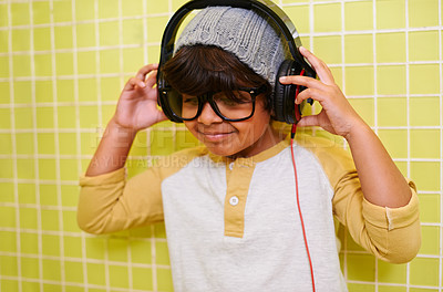 Buy stock photo Child, music and glasses with headphones in bathroom with song in a home. Radio, eyewear and youth fashion with a hipster boy listening to audio with with cool style in a house with spectacle frames