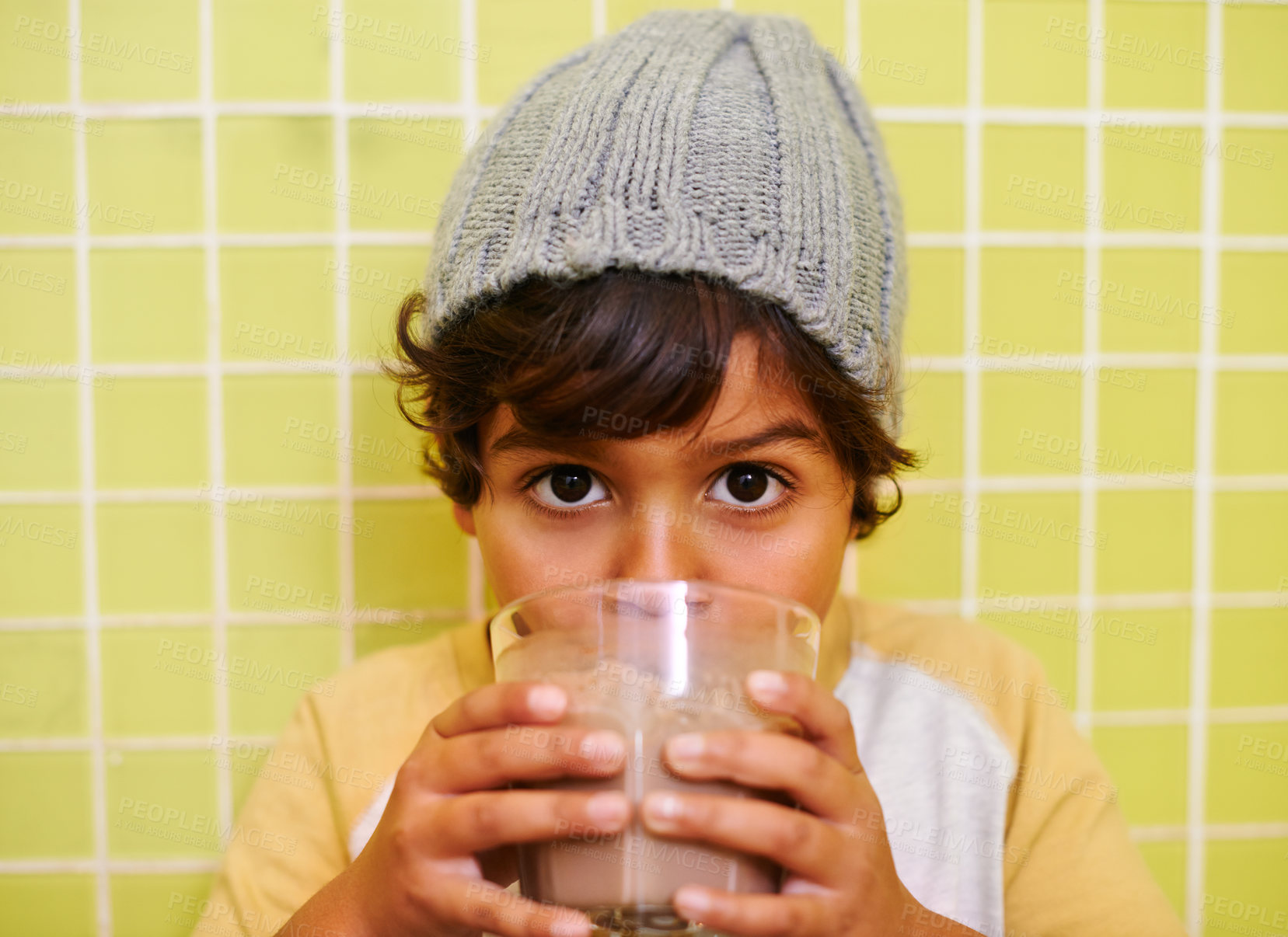 Buy stock photo Shot of a cute little boy drinking a milkshake
