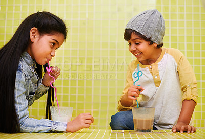 Buy stock photo Children, fun and siblings on a floor with milk, chocolate or smoothie games, challenge or drinking competition at home. Love, family and children bonding with liquid contest in house with milkshake