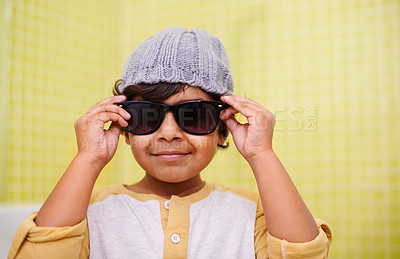 Buy stock photo Child, portrait and sunglasses with smile and fun with vision in a home. Happy, eyewear and youth fashion with an Indian boy with modern and casual style in a house with confidence and frames