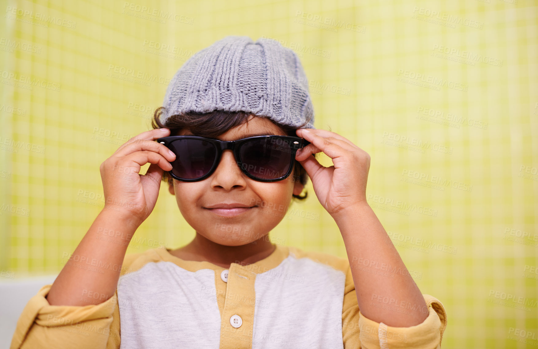 Buy stock photo Child, portrait and sunglasses with smile and fun with vision in a home. Happy, eyewear and youth fashion with an Indian boy with modern and casual style in a house with confidence and frames