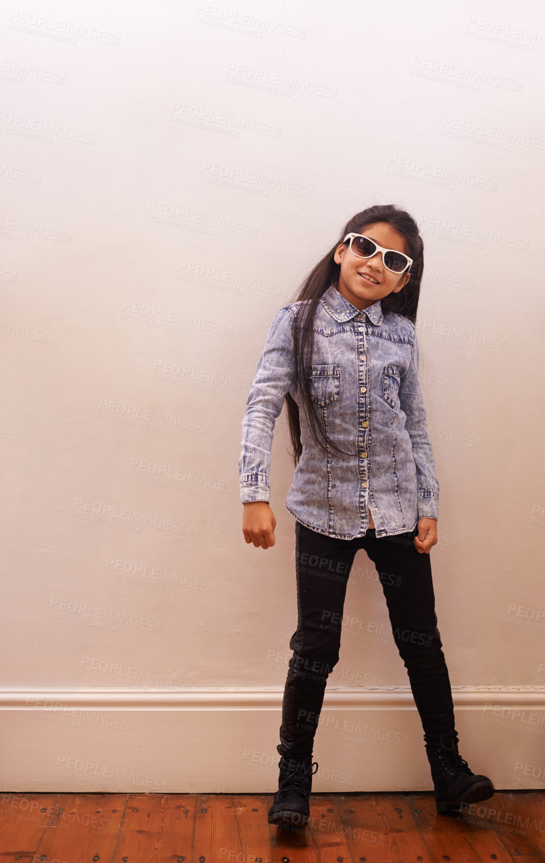 Buy stock photo Girl, child and fashion or sunglasses for style and looking cool on a wall background at home. Happy portrait of a kid or child with trendy clothes, casual and accessory or shades for fun indoors