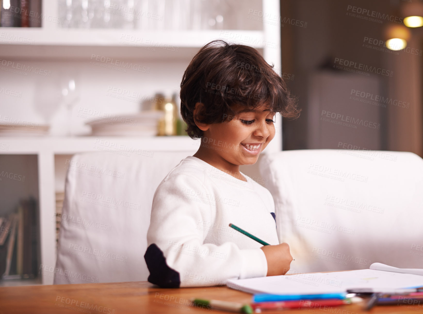 Buy stock photo Education, remote learning and boy in a kitchen with book, writing or homework assignment at home. Notebook, homeschool and happy kid person studying in a house with fun, color or art sketch lesson