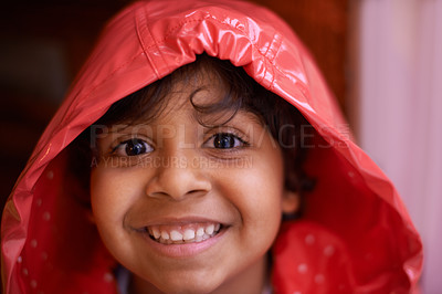 Buy stock photo Happy boy, portrait and fashion with red raincoat for rain, winter or cold season at home. Face of cute young child or kid with smile for protection, clothing or safety from rainy weather at house