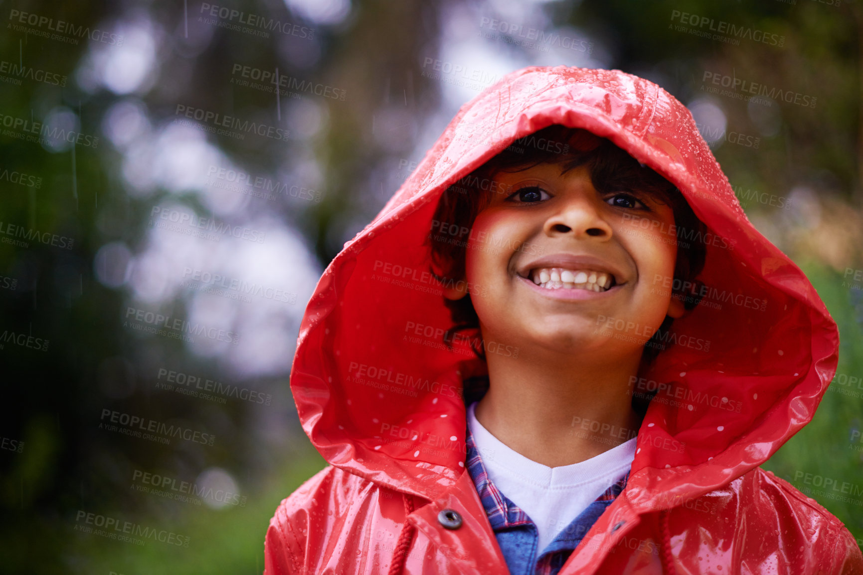 Buy stock photo Rain, coat and portrait of boy in a forest for adventure, freedom or exploring games in nature. Winter, travel and face of excited kid in India outdoor for learning, journey or freedom in a storm