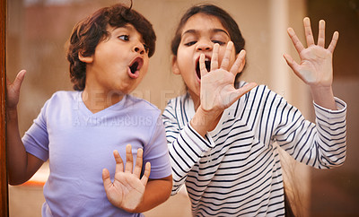 Buy stock photo Window, face and funny siblings with hand press comic in a house with silly, joke or goofy gesture. Glass, palm or Indian kids with humor, games or playing on vacation, holiday or weekend in India