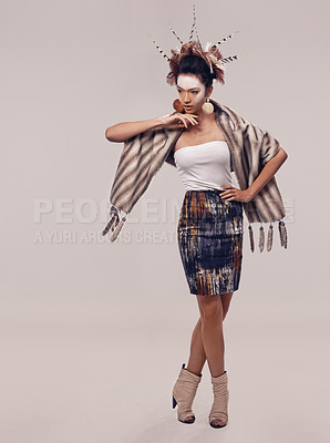 Buy stock photo Model, dancer or culture headdress in studio with feathers, fashion and tribal make up in trendy clothes. Native american woman, creative and indigenous cosmetics and accessories on grey background