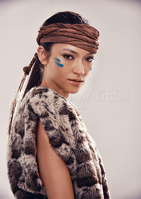 Buy stock photo Portrait, girl and Native American culture in studio with warrior makeup, confidence and tribe style. Indigenous fashion, face paint and serious woman in First Nations clothes on white background