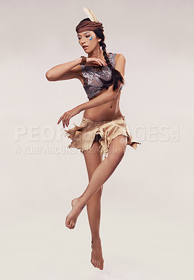 Buy stock photo Dance, woman and Native American fashion in studio with warrior makeup, confidence and tribe style. Indigenous culture, face paint and girl in First Nations clothes on white background in performance