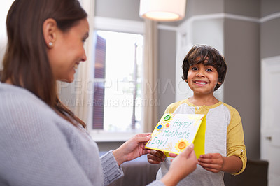Buy stock photo Portrait of a son holding a mother's day card with his mom