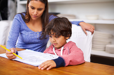 Buy stock photo Woman, help and child in house with book for homework, learning and education for grades, study and development. Diverse people, mother and boy with note and pencil for teach, writing and childhood