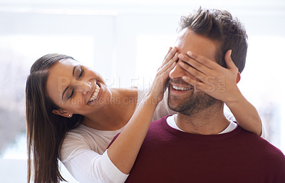 Buy stock photo Shot of a young woman covering her husband's eyes for a surprise