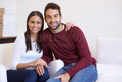 Buy stock photo A husband and wife being affectionate while sitting together on the sofa