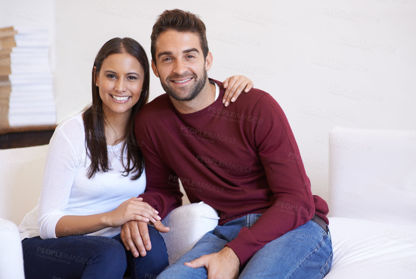 Buy stock photo A husband and wife being affectionate while sitting together on the sofa