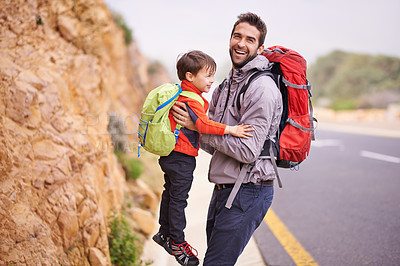 Buy stock photo Father, child and portrait with hike, backpack and travel with smile and support in nature by road. Kid, adventure and laugh with love, trust and bonding together with family and journey for holiday