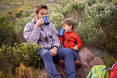 Buy stock photo Father, child and drinking with hiking, backpack and camping with smile and support in nature. Kid, adventure and mountain with love, trust and bonding together with family and travel for holiday