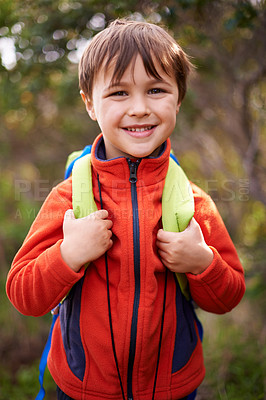 Buy stock photo Child, smile and portrait for hiking and adventure for young and growing up for adolescent outdoor. Boy or kid with backpack and happy for trip, holiday or walk in nature for childhood and fun