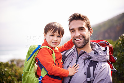 Buy stock photo Dad, child and portrait with hiking, backpack and travel with smile and support in nature. Kid, adventure and mountain with love, trust and bonding together with family and journey for holiday