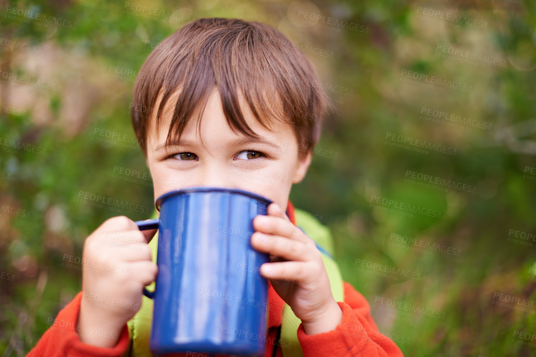 Buy stock photo Shot of a adorable little boy drinking from a mug while on a camping trip