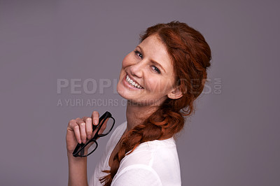Buy stock photo Young woman, portrait and excited in studio with glasses for optometry choice, frame and confidence. Happy face of a young person or model happy for specs, eyewear or vision care on a gray background
