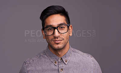 Buy stock photo Young man, portrait and glasses in studio for eye care, vision and new frame with confidence on a gray background. Happy face of a young person or model in spectacles, eyewear and vision with lens