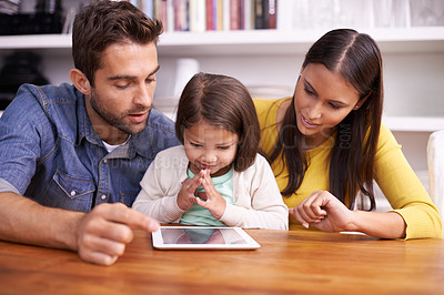 Buy stock photo Mom, dad and child at table with tablet for teaching, learning and support in education with love. Elearning, digital app and parents with girl for homeschool, growth and development in online games