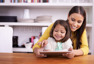 Buy stock photo A mother and daughter working together on a tablet