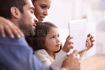 Buy stock photo Home, family and parents with girl, tablet and playing online games with connection and bonding together. Apartment, mother or father with daughter and technology with digital app, movies or internet