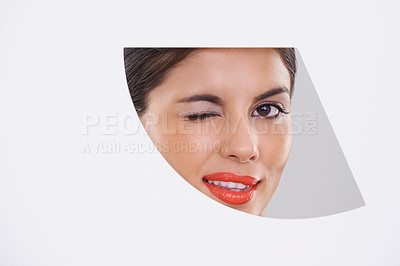 Buy stock photo Portrait, woman and makeup or beauty in cutout in studio for cosmetics, skincare and dermatology with wink. Face of model or young person with foundation in geometric mockup on a white background