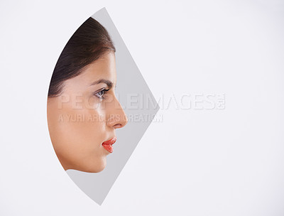Buy stock photo Shot of a beautiful young woman through a cut out shape