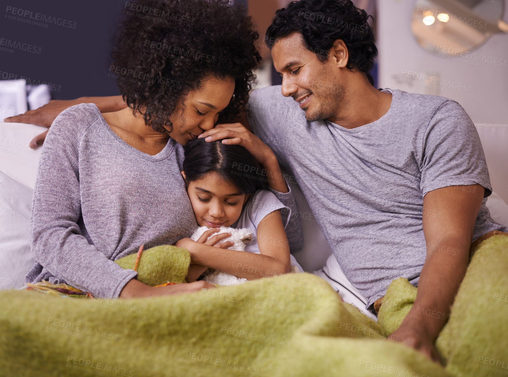 Buy stock photo Shot of a mother and father reading to their daughter