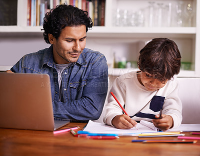 Buy stock photo Shot of a father helping his son with his homework