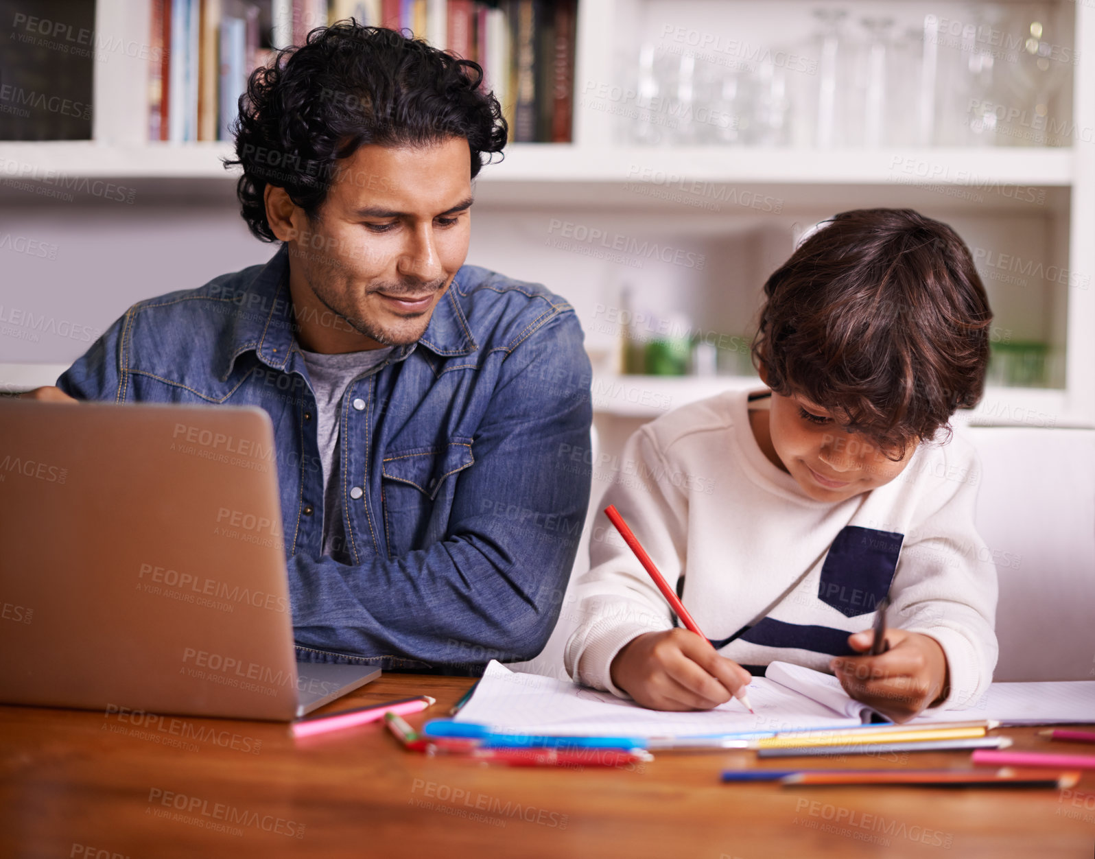 Buy stock photo Shot of a father helping his son with his homework