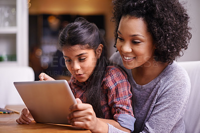 Buy stock photo Shot of a mother and daughter using a digital tablet together
